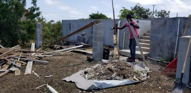 barbudan-clearing-out-damage-from-home